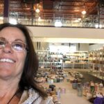 Woman smiling in a colorful store interior.
